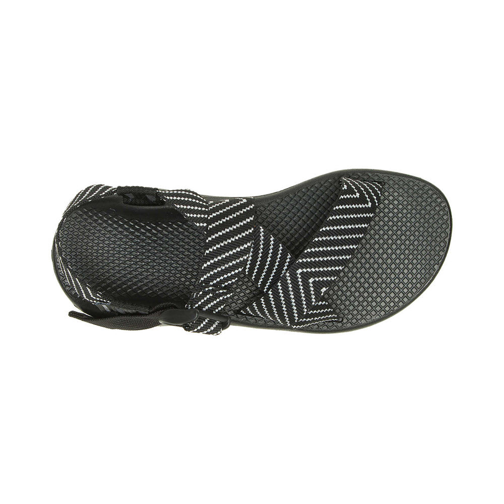 A pair of black and white patterned slip-on sneakers with a ChacoGrip rubber outsole, displayed from a top-down view. (CHACO MEGA Z/CLOUD VIBIN B+W - WOMENS by Chaco)