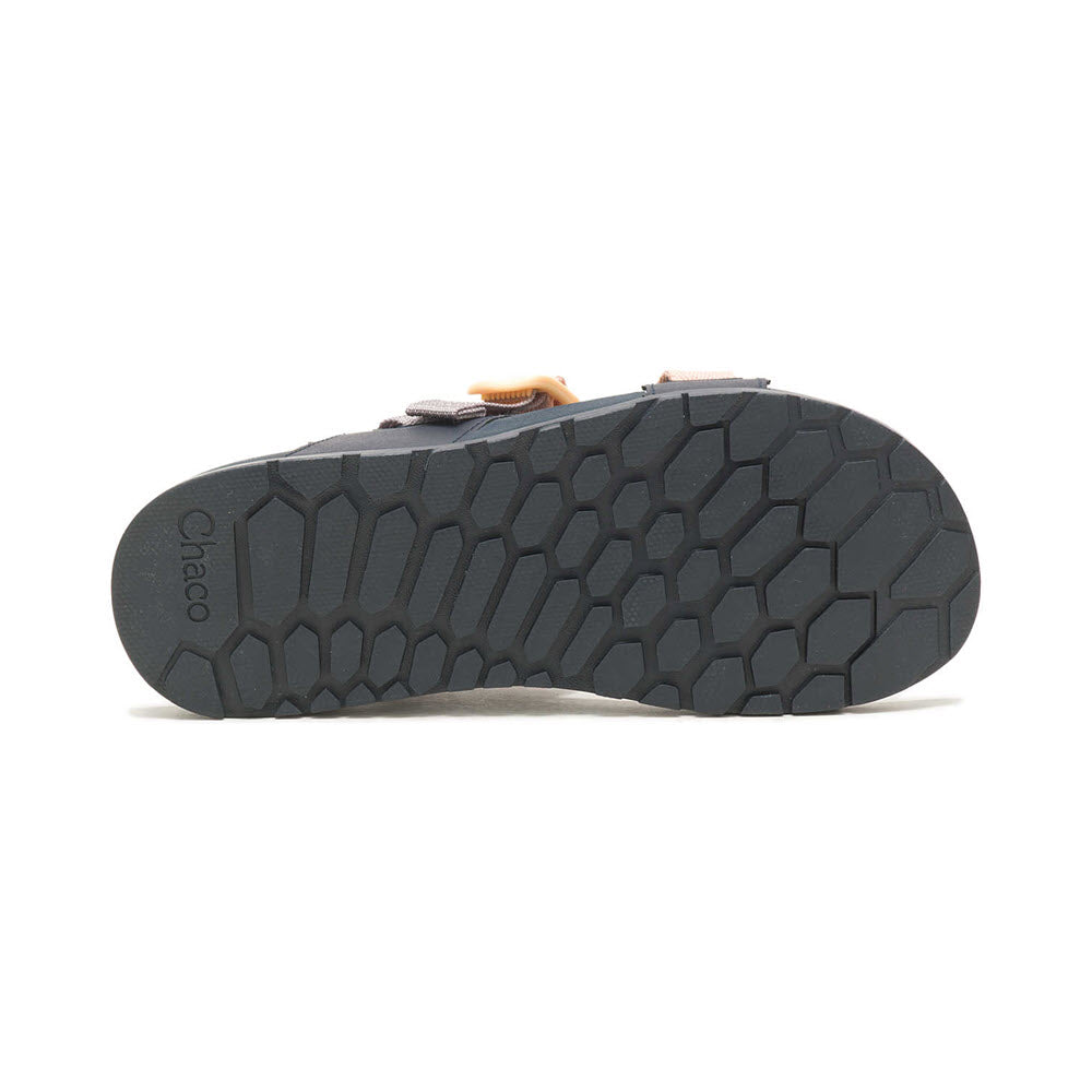 Sentence with replaced product name: Sole of a Chaco Lowdown sandal displaying a hexagonal tread pattern, isolated on a white background.
