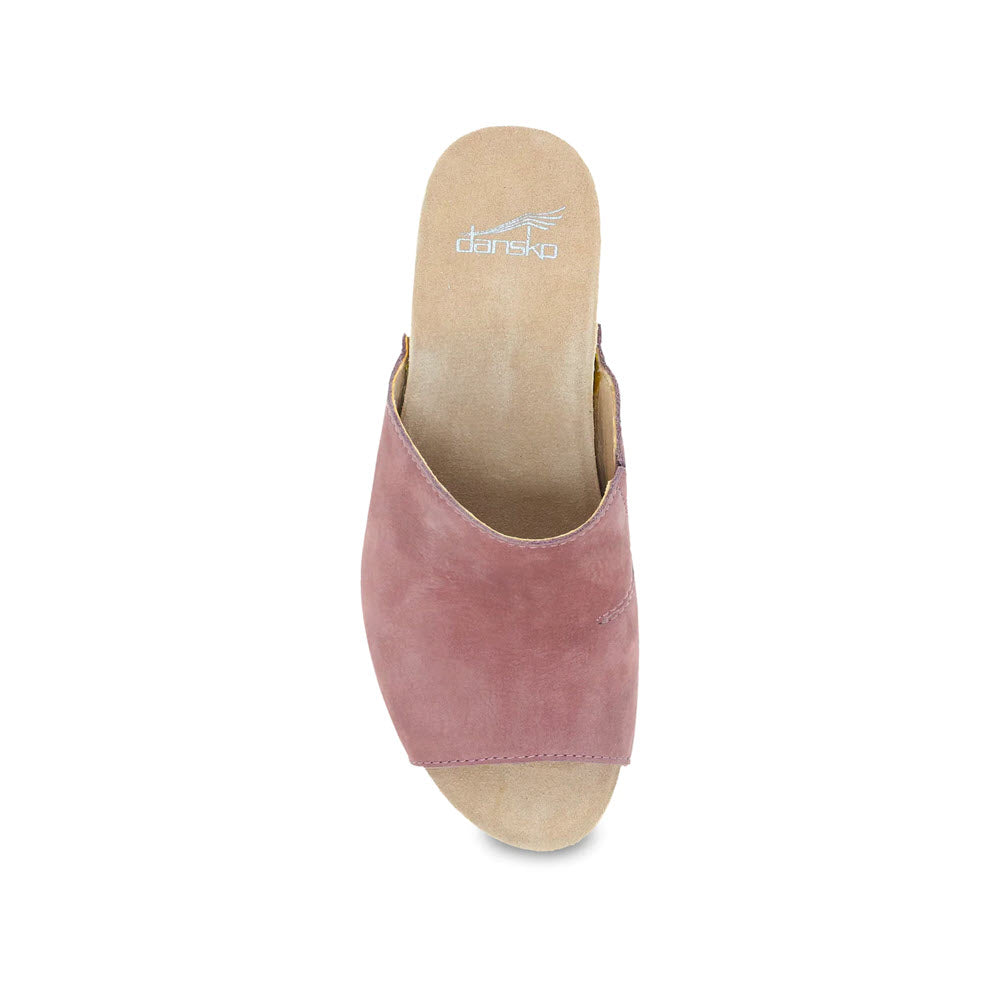 Top view of a dusty rose colored women&#39;s Dansko Tandi slide sandal with an open toe and a flat sole, featuring a Dansko logo on the insole.