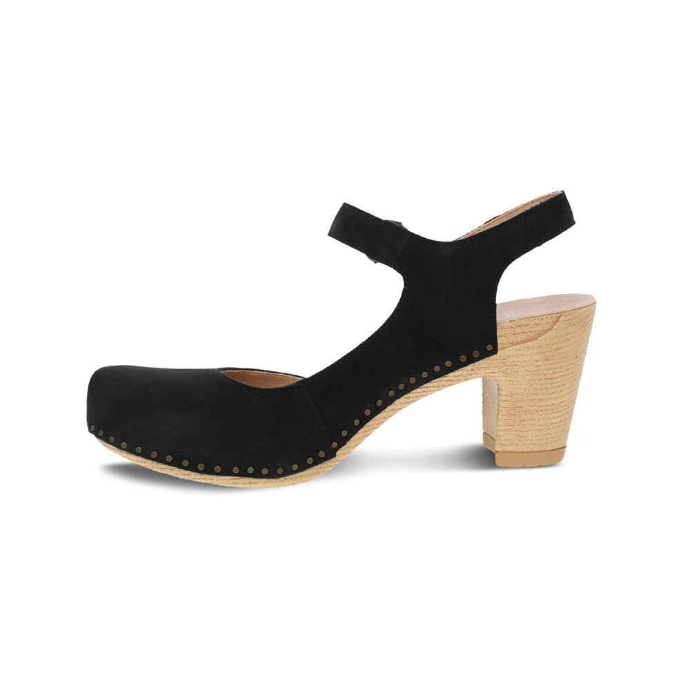 Black suede Dansko Taytum mary jane shoe with a chunky wooden heel and brass stud detailing, displayed against a white background.