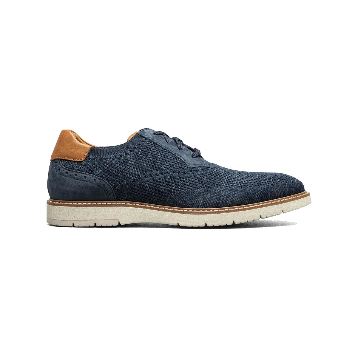 A single navy blue Florsheim Vibe Knit Plain Toe Oxford men&#39;s dress shoe with brogue detailing and a contrasting tan leather heel, set against a white background.