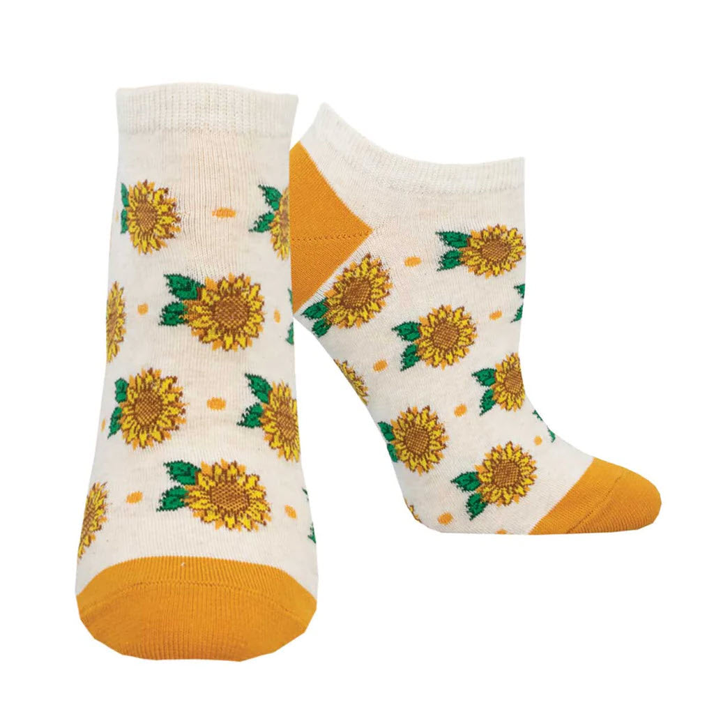 A pair of SOCKSMITH SHORTIE SOCKS SUNFLOWER IVORY - WOMENS with yellow toe caps and sunflower patterns all over, isolated on a white background.