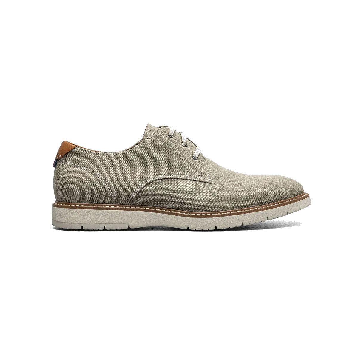 Side view of a light gray Florsheim men&#39;s Vibe Canvas Plain Toe Oxford shoe with tan leather trim and white soles against a white background.