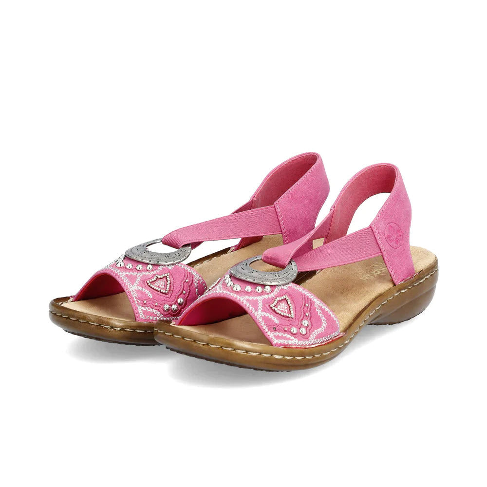 A pair of Rieker pink, rhinestone-studded sling-back sandals on a white background.