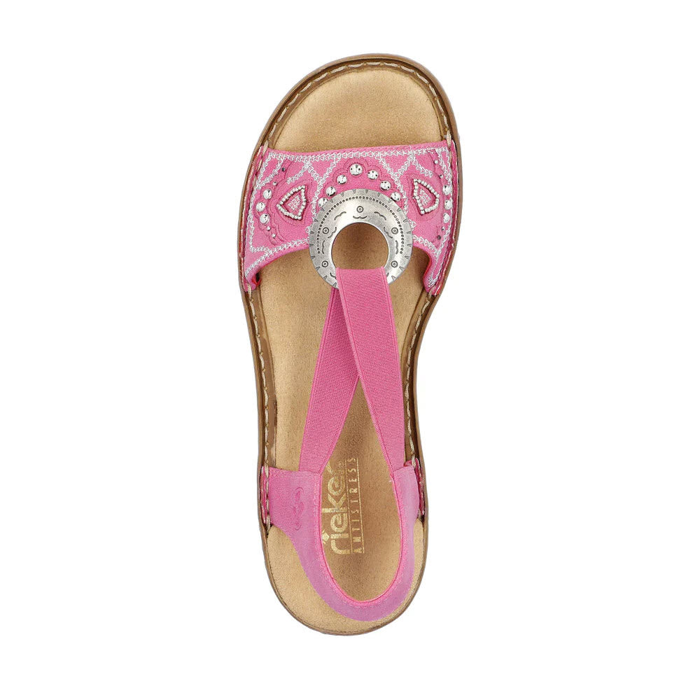 Top view of a Rieker pink sling-back sandal with decorative stitching and a circular metallic accent.