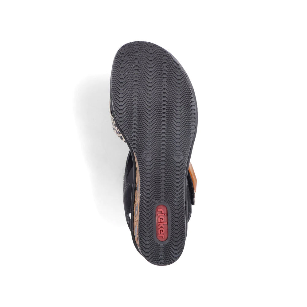 A single flip-flop with a black sole and navy straps placed against a white background, viewed from the bottom, reminiscent of Rieker RIEKER BIG BUCKLE WEDGE LEOPARD MULTI - WOMENS ladies&#39; sandals.