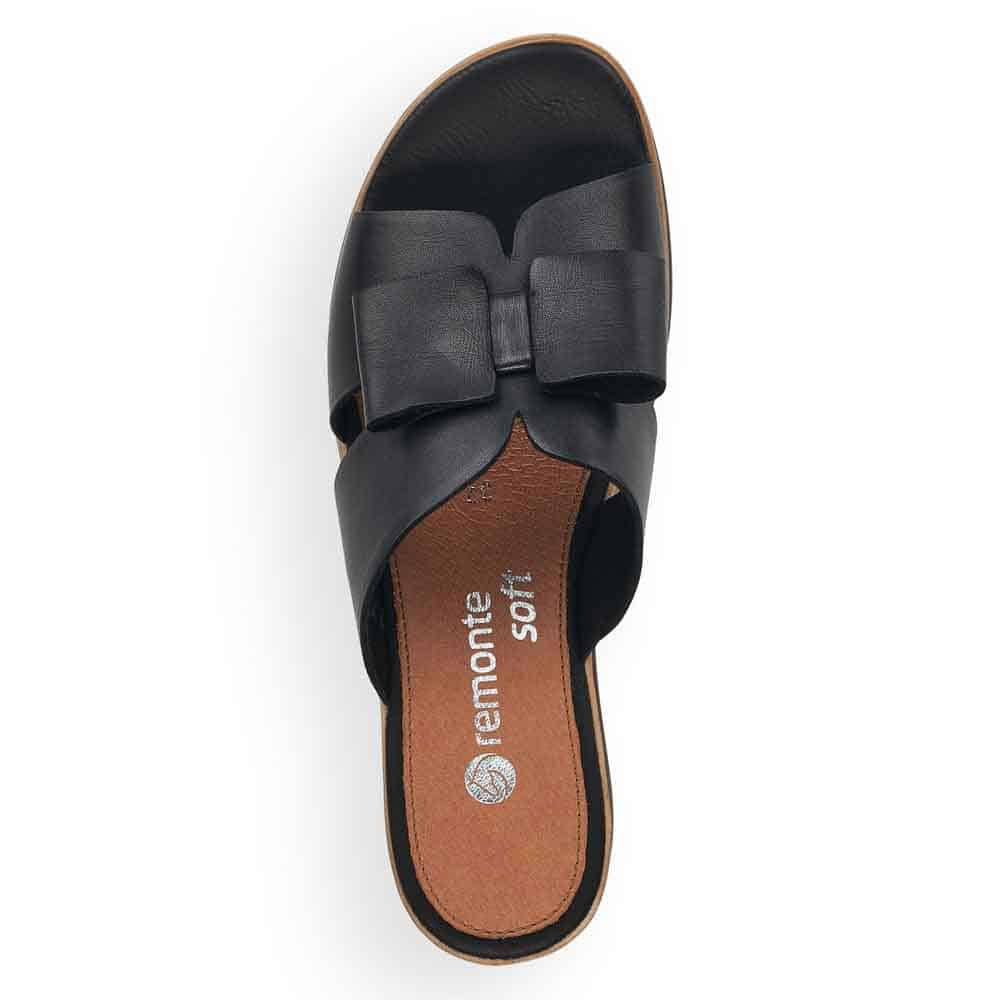 Top view of a single Remonte black leather wedge summer slide sandal with a thick strap and a cushioned insole marked &quot;etnonte soft.