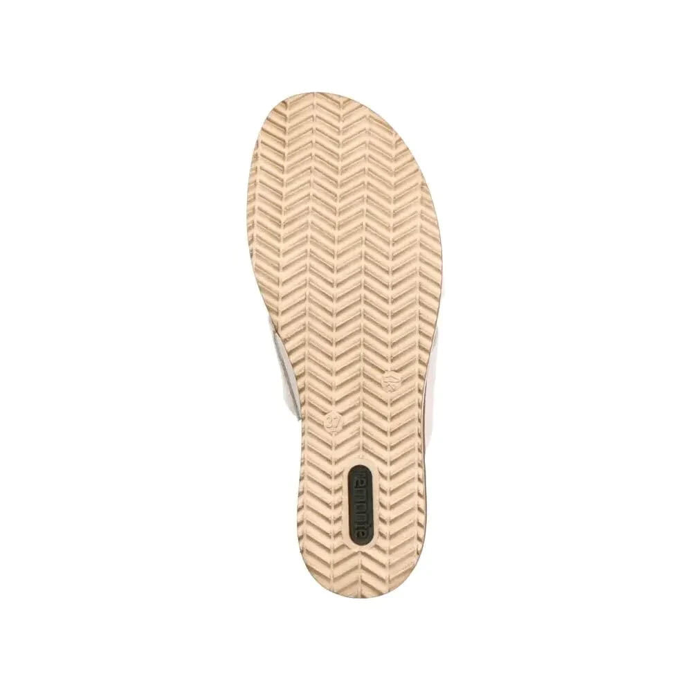 Beige rubber shoe sole with herringbone pattern and cushioning, featuring a black rectangular logo embedded near the heel of the Remonte Bow Wedge Sandal White - Womens.