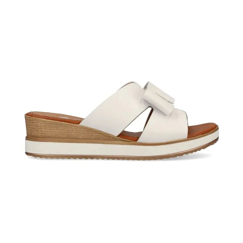 A Remonte women&#39;s slide sandal with a cushioning sole and crossover straps, isolated on a white background.