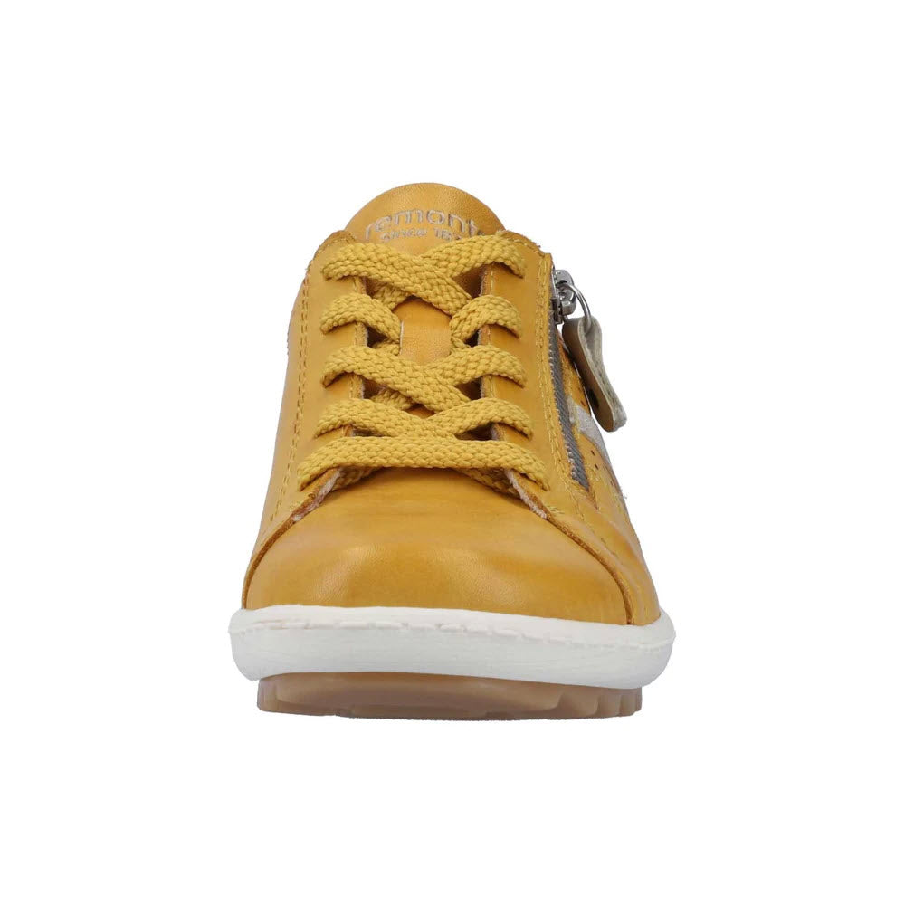 Front view of a single Remonte mustard yellow leather sneaker with laces, a removable insole, and a white sole, isolated on a white background.