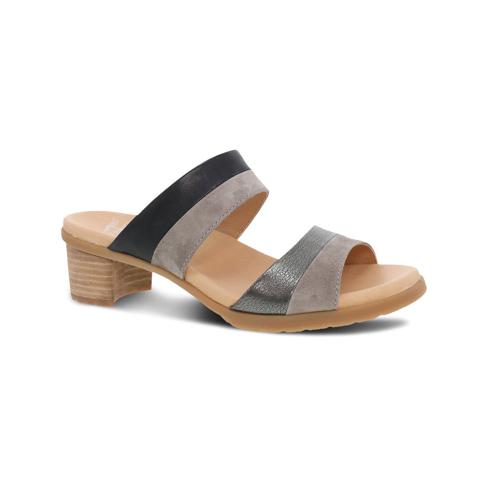 A Dansko sandal with two wide, crisscrossing leather straps in elegant colors of black and silver, set on a low, stacked wooden heel, isolated on a white background.