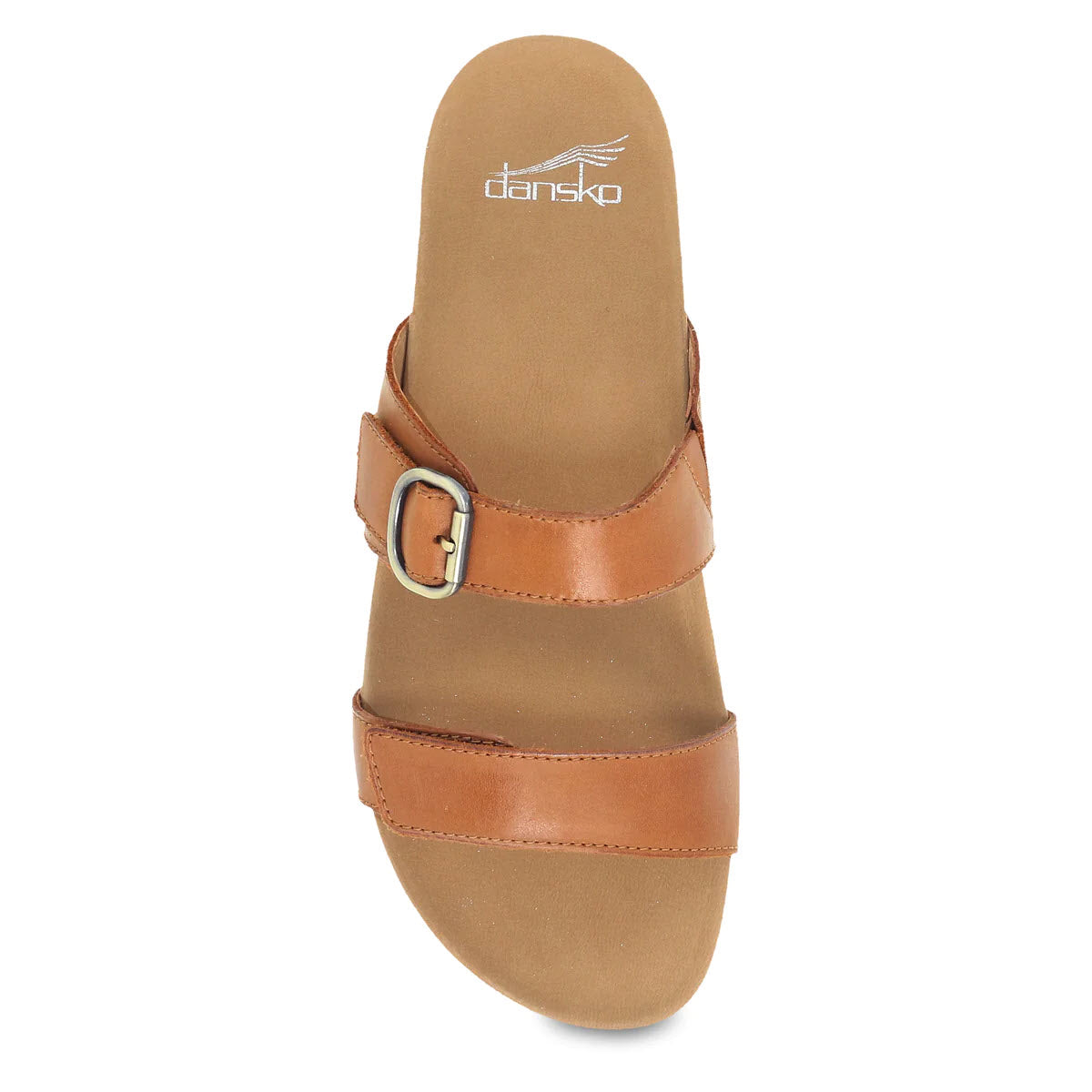 Top view of a single tan leather Dansko Justine Luggage slide sandal with two straps and a buckle, isolated on a white background.