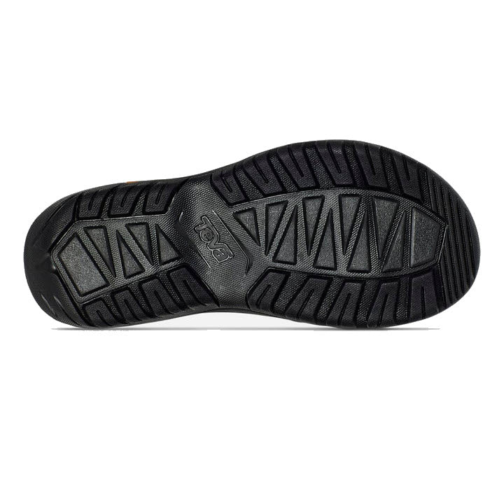 Black rubber sole of a Teva shoe with textured traction patterns and logo imprint.
