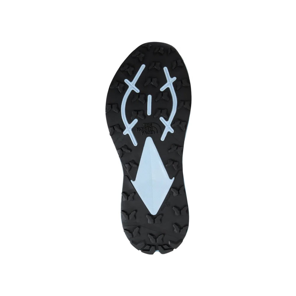 Sole of a hiking boot with a black tread pattern, featuring a blue triangular design in the center and the word &quot;trekken&quot; in white, integrated with NORTH FACE VECTIV ENDURIS 3 STEEL BLUE/CAVE BLUE - WOMENS technology.