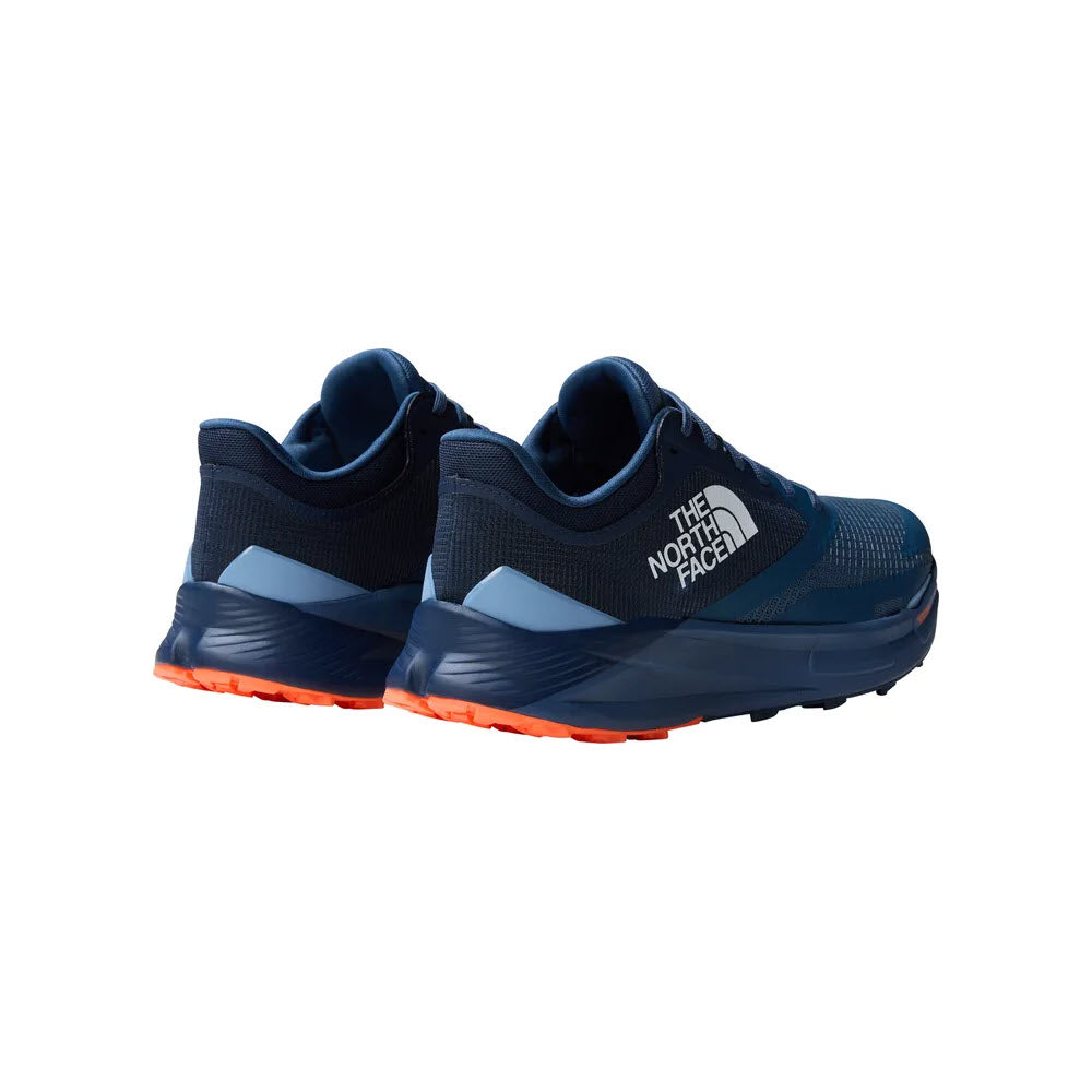 A pair of dark blue North Face VECTIV Enduris 3 trail running shoes with grey accents and bright orange soles, featuring VECTIV technology, isolated on a white background.