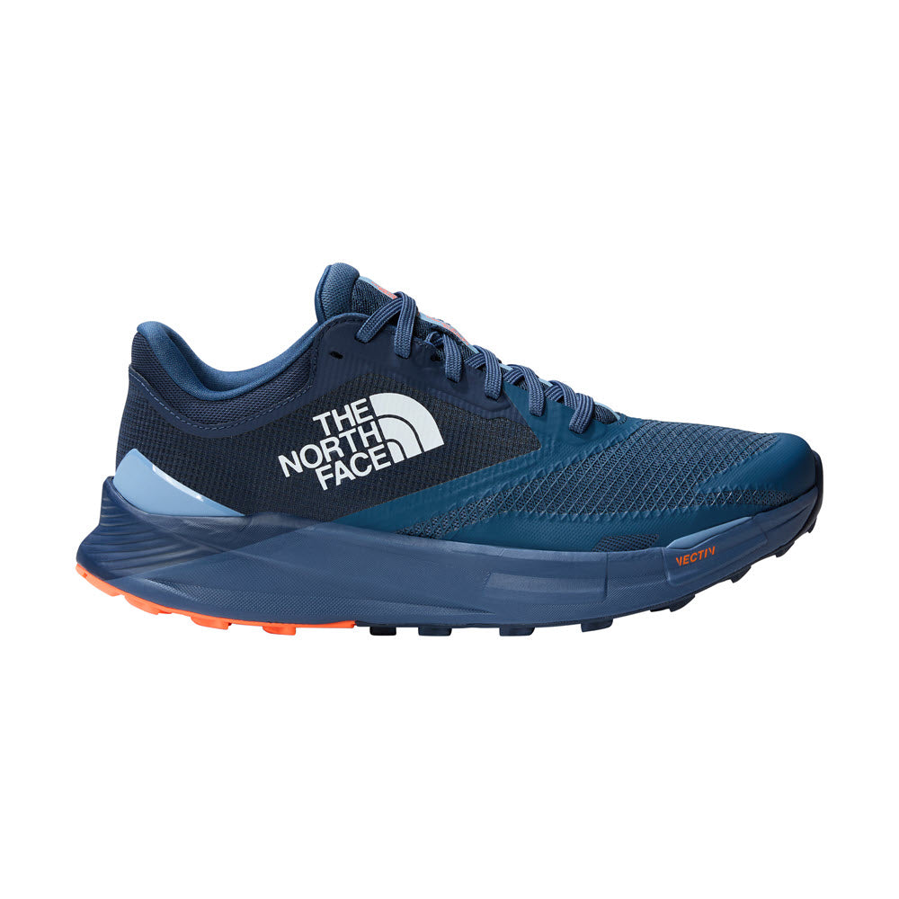 Side view of a Shady Blue/Summit Navy North Face Vectiv Enduris 3 men&#39;s trail running shoe with orange accents on the sole, featuring VECTIV technology.
