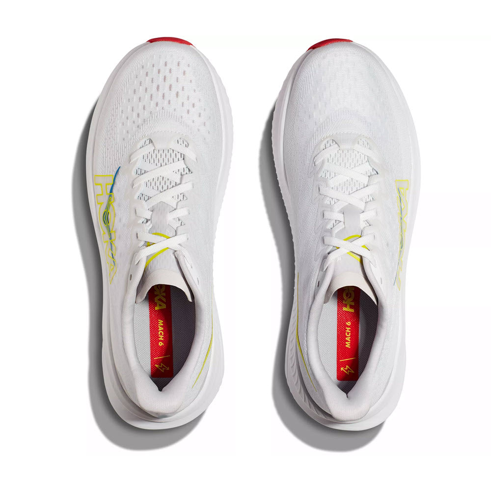 A top-down view of a pair of Hoka Mach 6 white, lightweight trainers with red accents and visible brand logos.
