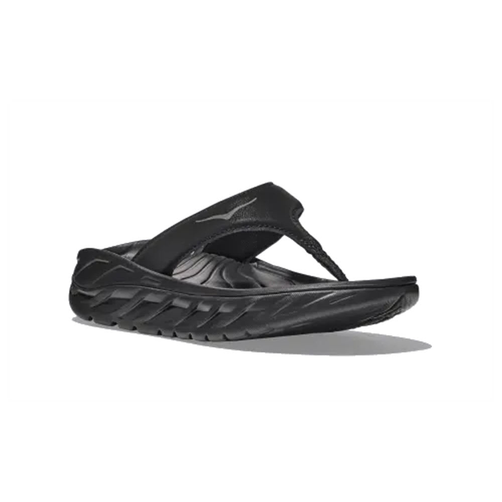 Hoka black slip-on casual shoe with a textured sole and Meta-Rocker geometry upper, displayed against a white background.