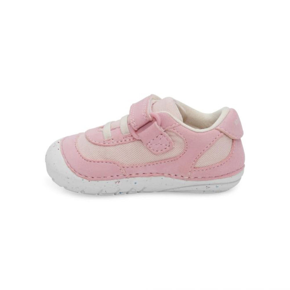 A single pink toddler shoe with velcro straps and a memory foam interior, featuring a white sole on a white background. Stirde Rite Sm Sprout Pink - Kids from Stride Rite.