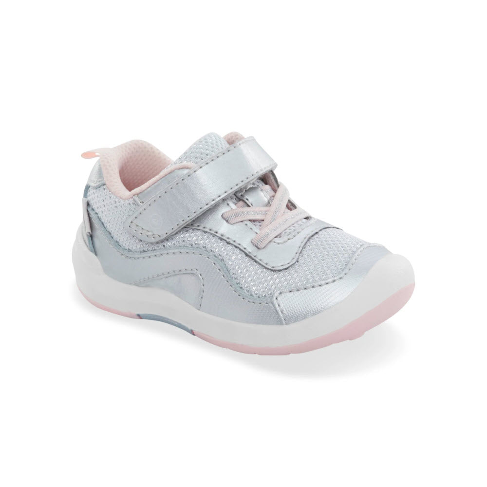 A child&#39;s Stride Rite SRT Winslow 2.0 Silver sneaker with light gray and pink tones, featuring a hook-and-loop strap and glitter accents.