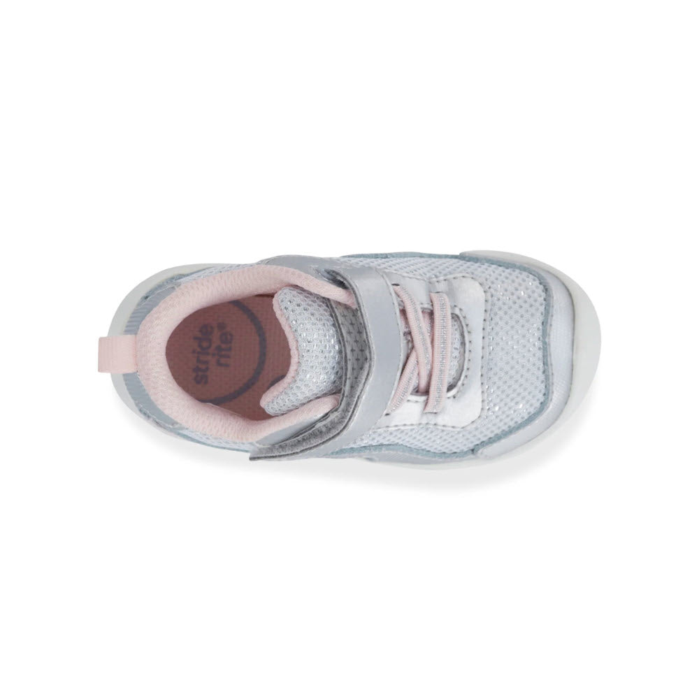 Top view of a single light gray and pink Stride Rite SRT Winslow 2.0 Silver Sneaker with white laces on a white background.
