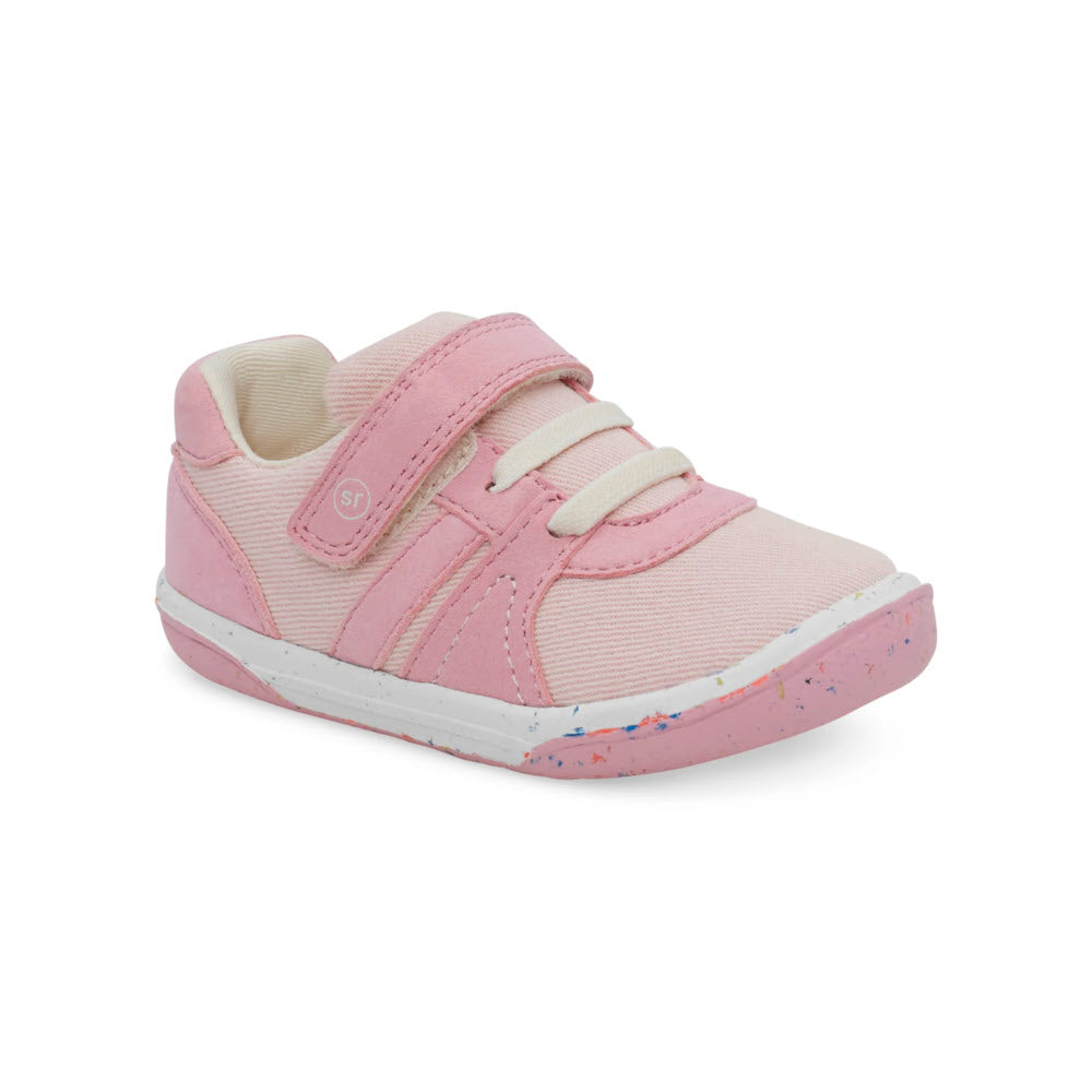 A single pink toddler&#39;s Stride Rite SR Fern Pink - Kids Sneaker with white velcro straps and a speckled sole, displayed against a white background.
