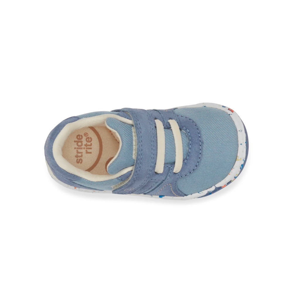 A single blue Stride Rite SR Fern Blue - Kids child&#39;s shoe with velcro straps viewed from above, made from organic cotton and seaweed fiber.
