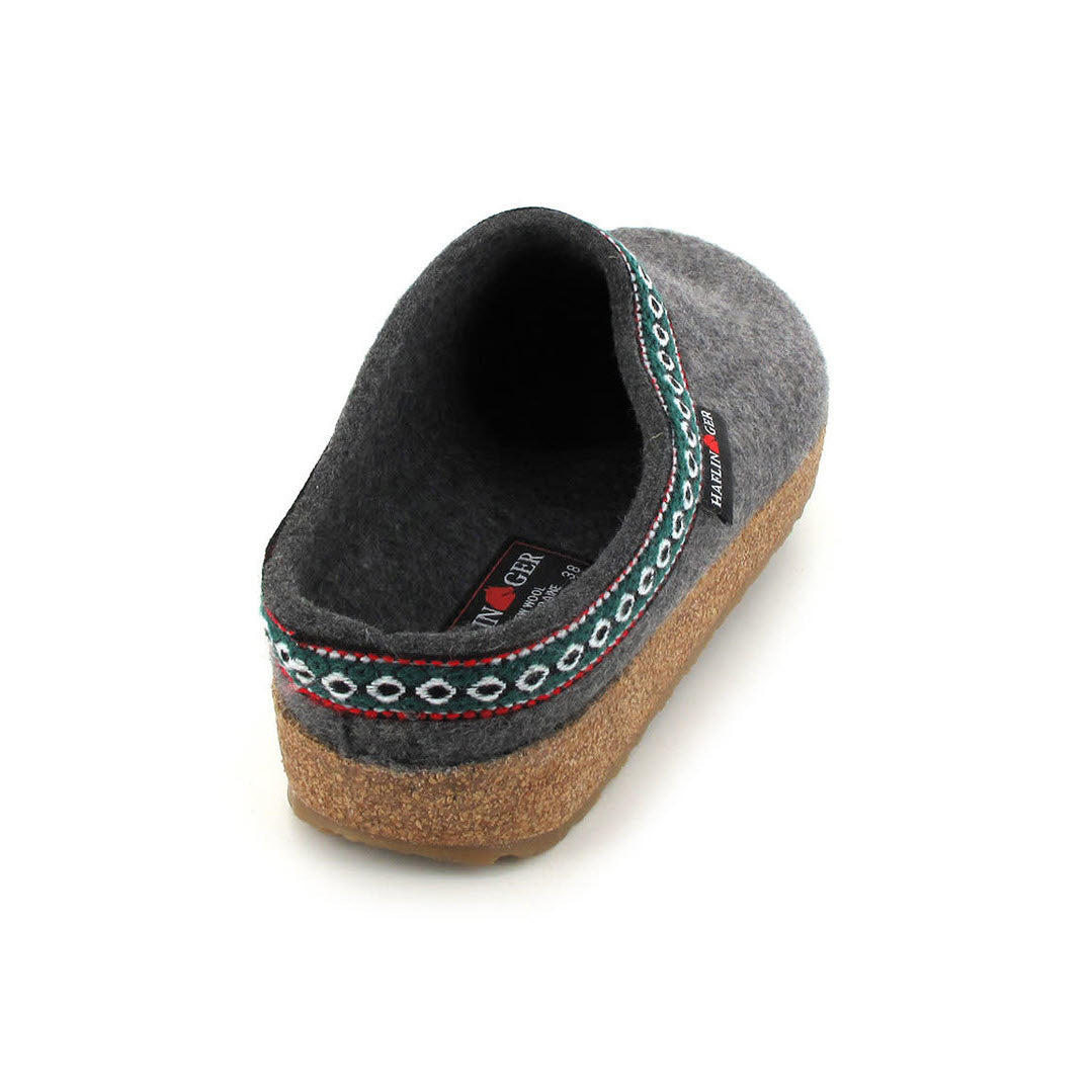 A single HAFLINGERS GZ GREY - WOMENS by Haflinger footwear with a decorative embroidered band and a cork sole, isolated on a white background.