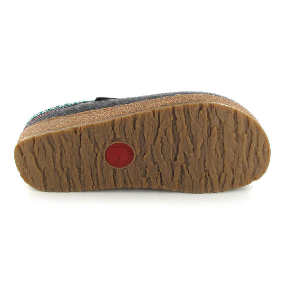 Side view of a Haflingers shoe sole with a textured pattern and a small red circular logo.