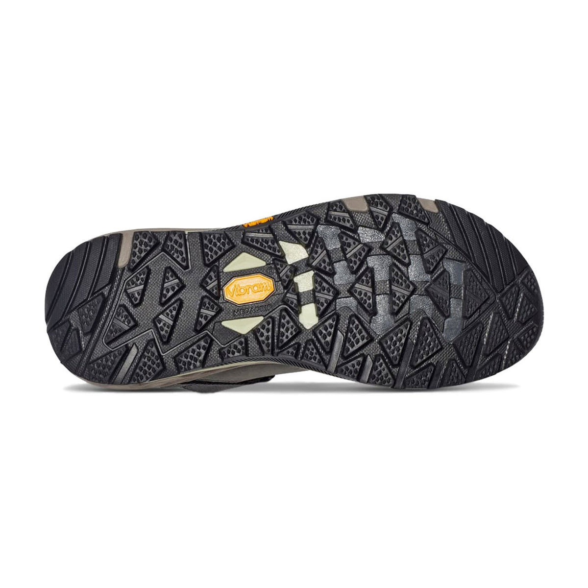Bottom view of a TEVA GRANDVIEW GTX LOW BRACKEN/BURLWOOD - WOMENS hiking shoe sole featuring a detailed black tread pattern with triangular shapes and a branded yellow logo in the waterproof women&#39;s hiker.