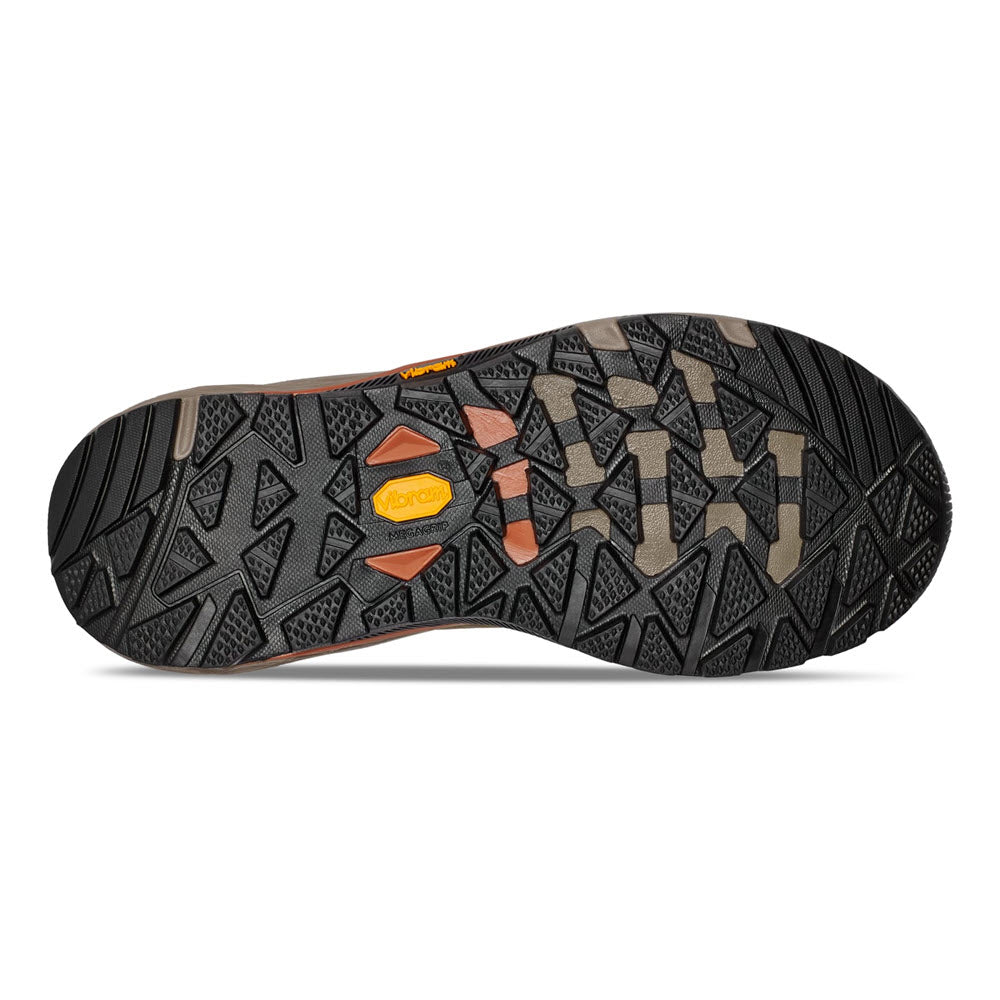 Sole of a Teva Grandview GTX Low Rainforest Brown/Dark hiking shoe with a patterned tread design in black and gray, featuring orange Teva brand logos and a Vibram Megagrip outsole.