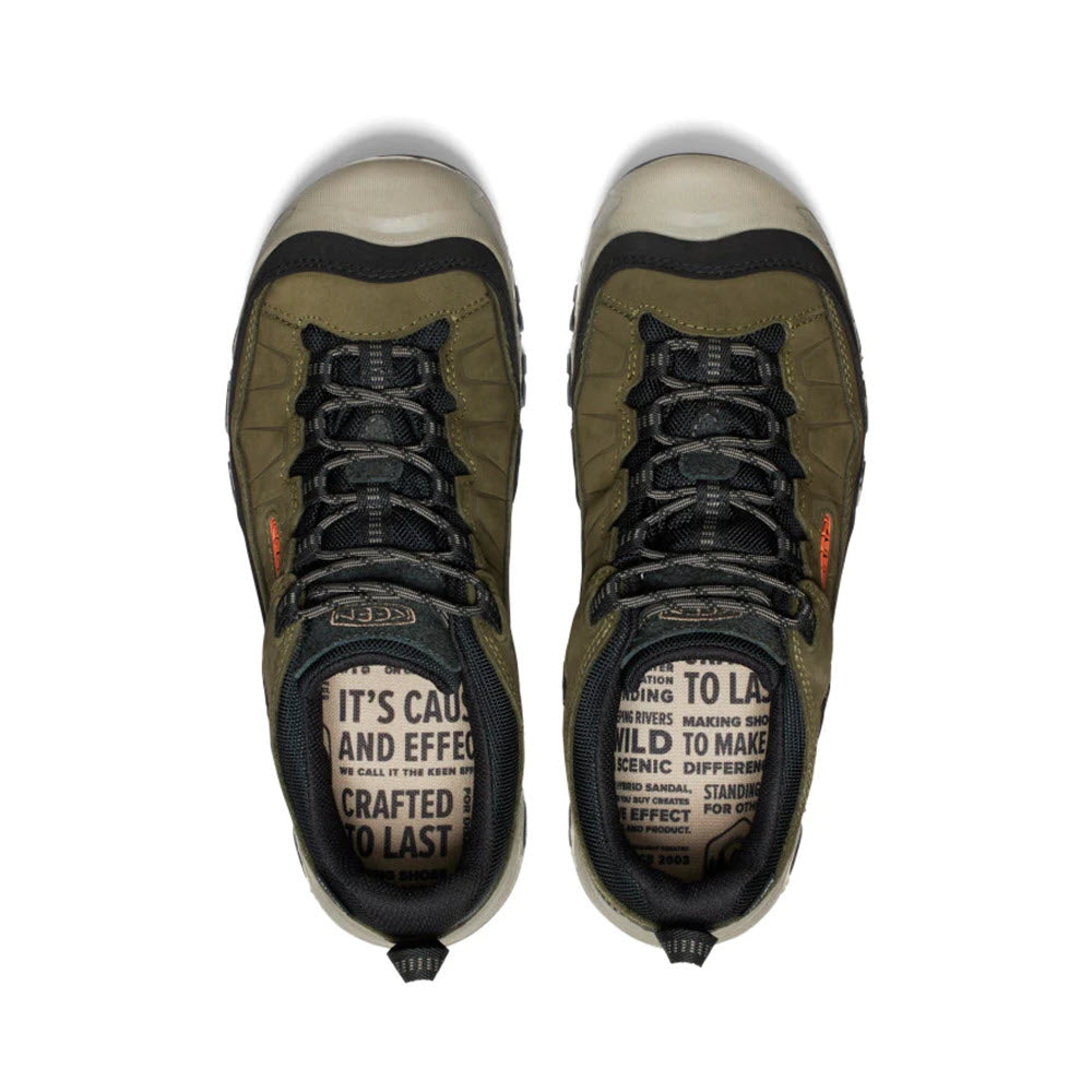 A pair of durable Keen Targhee IV WP dark olive and gold flame hiking boots with text on the tongues reading &quot;it&#39;s caused and effected to last&quot; and other markings.