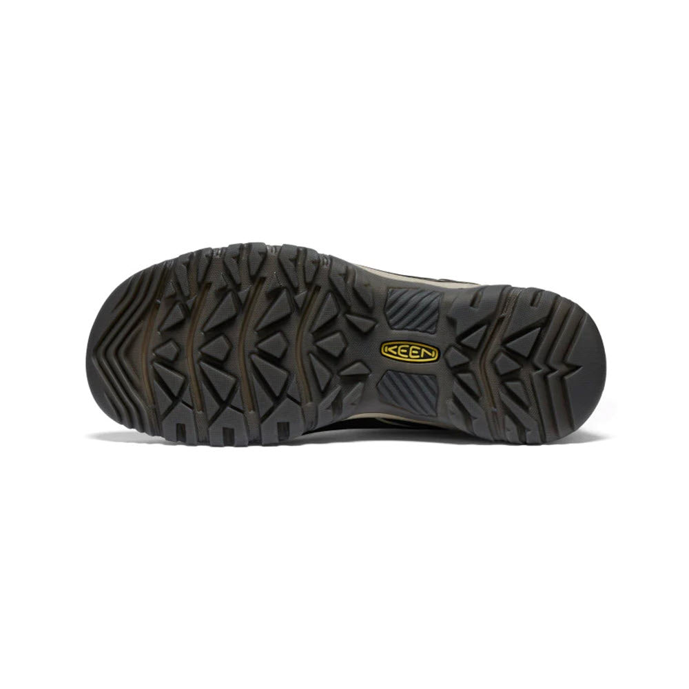 Close-up view of the bottom of a black, durable Keen Targhee hiking shoe, showing a detailed tread pattern and the Keen logo in the center.
