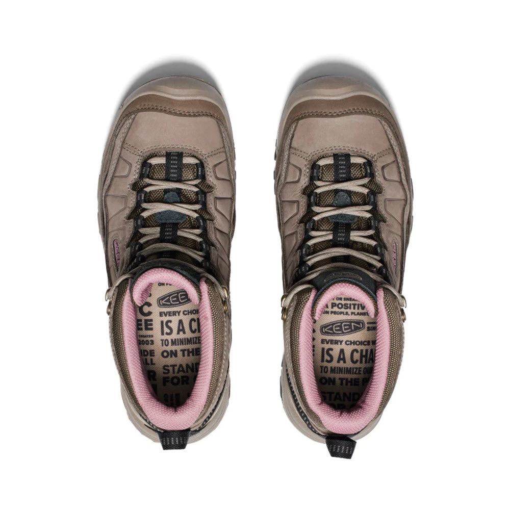 A pair of gray and pink Keen Targhee IV Mid WP Brindle/Nostalgia Rose hiking shoes viewed from above, featuring motivational text on the tongue.