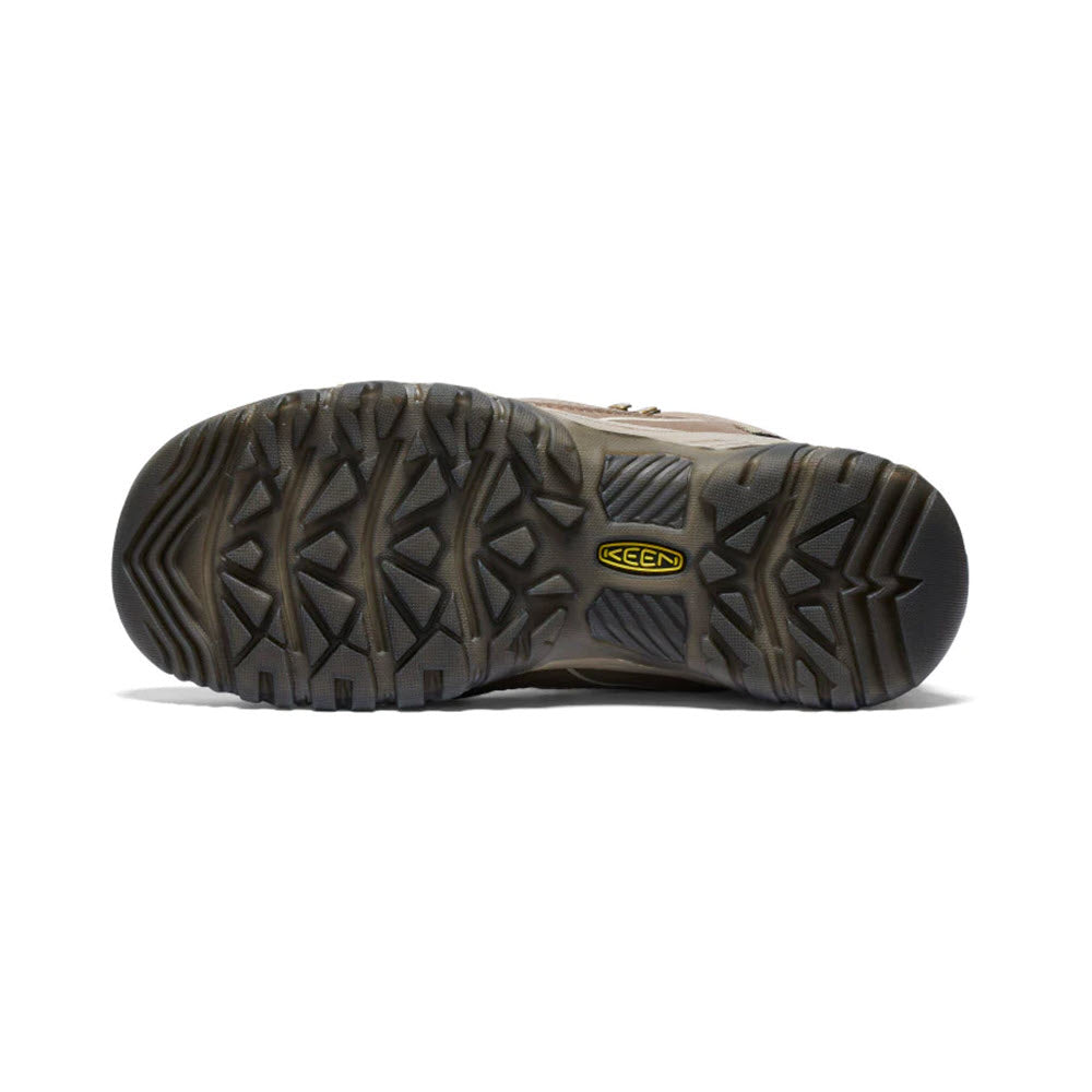 Sentence with product and brand name: Sole of a brown Keen Targhee IV Mid WP Brindle/Nostalgia Rose hiking boot showing the tread pattern and brand logo.