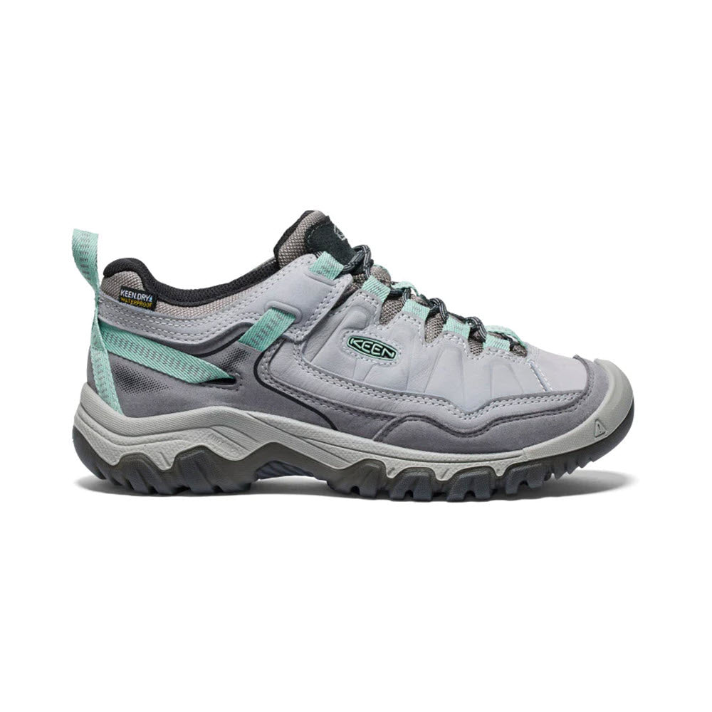 A pair of light gray durable Keen Targhee IV WP Alloy hiking shoes with teal accents on a white background.