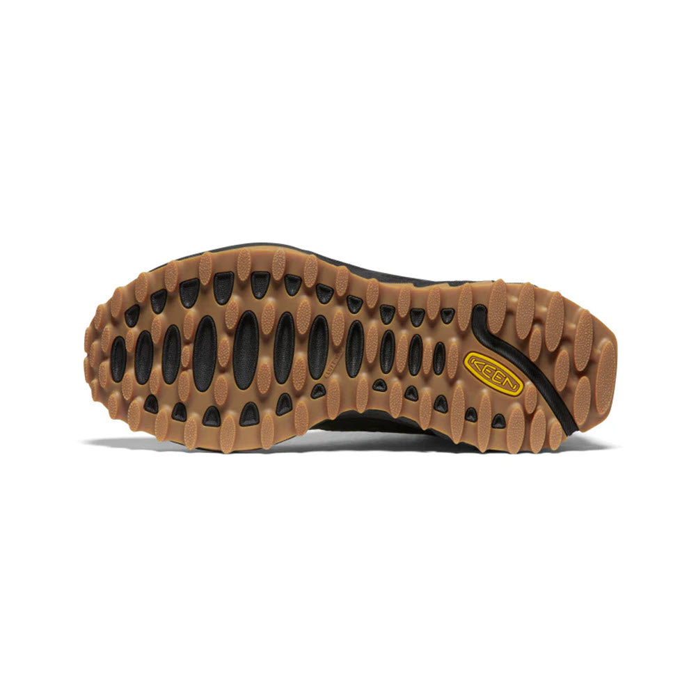 Bottom view of a brown Keen Zionic hiking boot sole with deep treads, showing the brand logo.