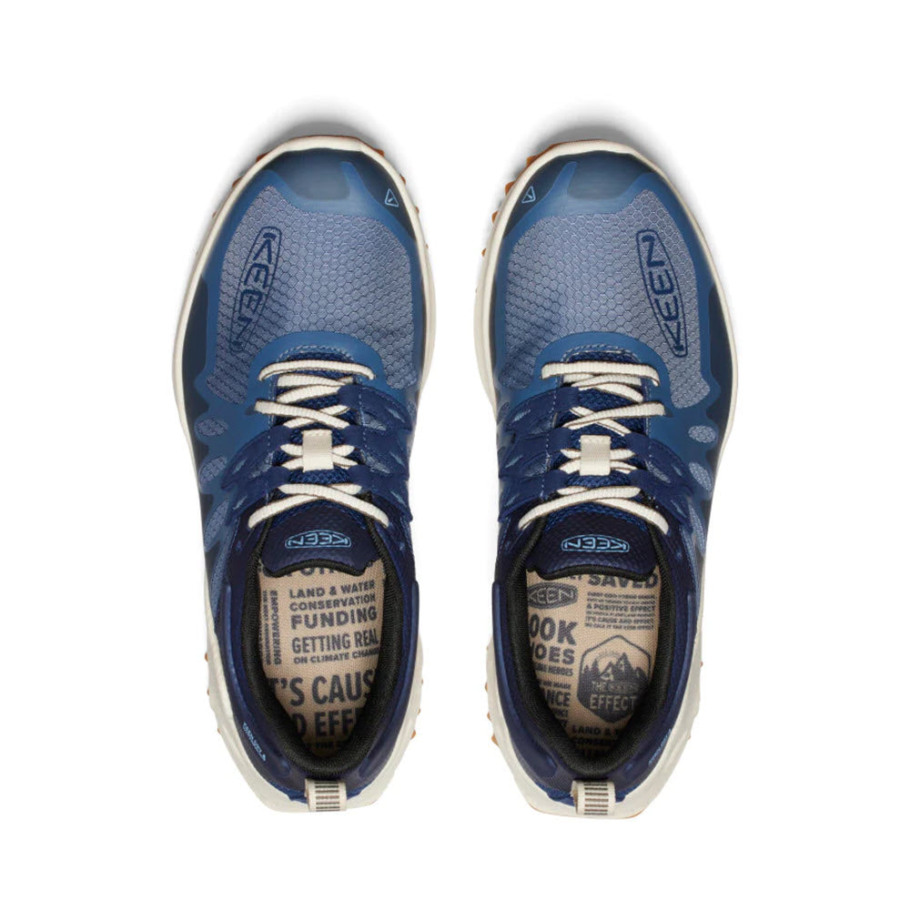 A pair of blue Keen Zionic WP Vintage Indigo/Faded Denim - Men&#39;s running shoes with white laces viewed from above, featuring Zionic logos and text on the insoles.