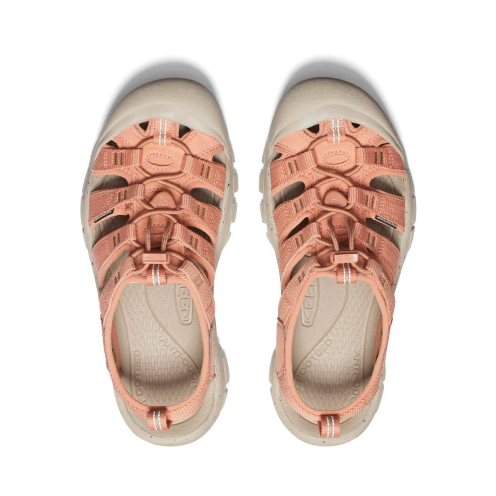 A top view of a pair of peach-colored Keen Newport H2 Cork sandals, showing the contoured insoles and adjustable straps.