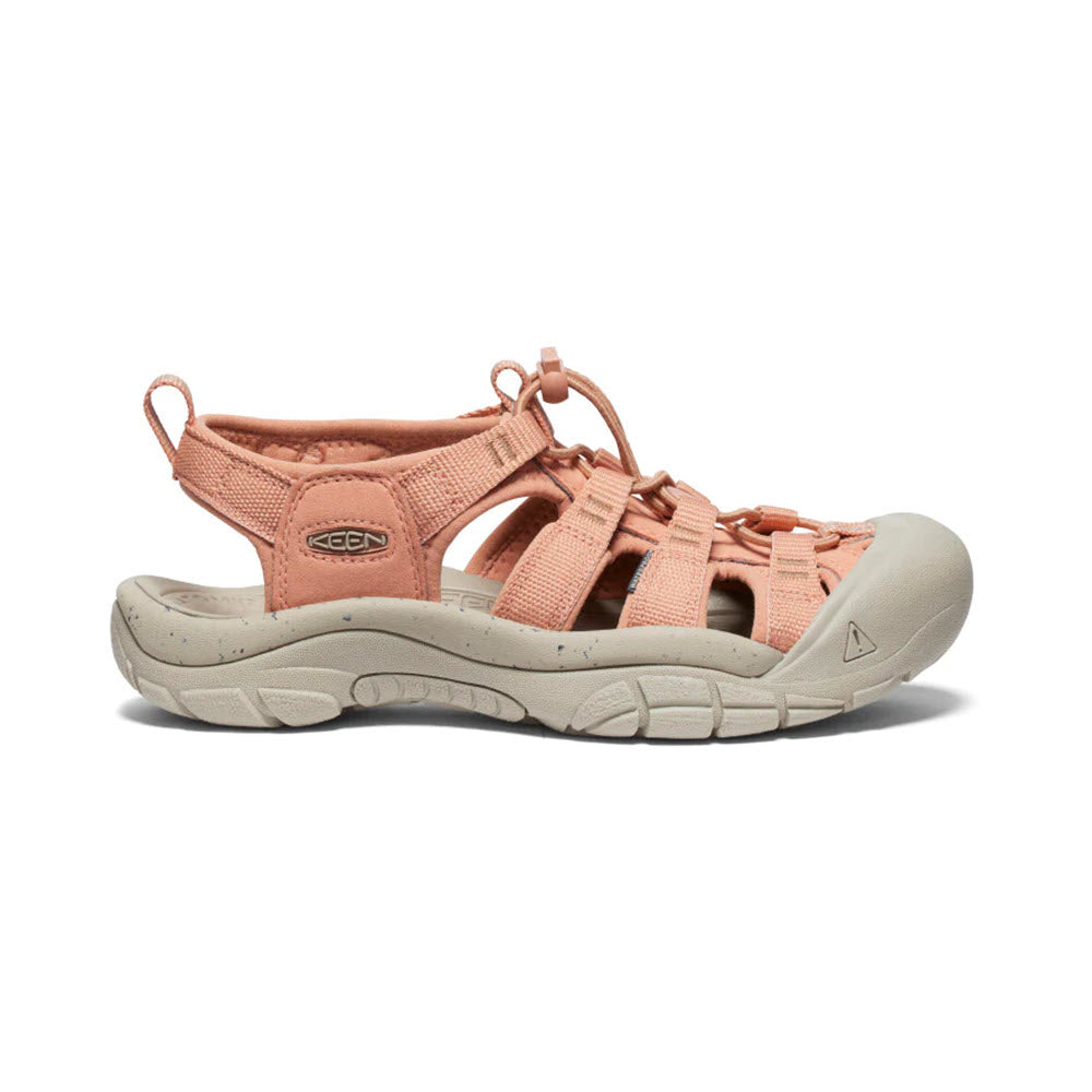 A pair of light pink Keen Newport H2 Cork sandals displayed on a white background.