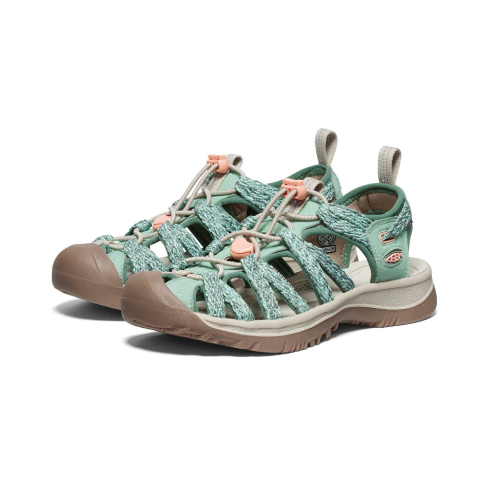A pair of Keen Whisper Granite Green hiking sandals with strappy uppers and rugged soles on a white background.