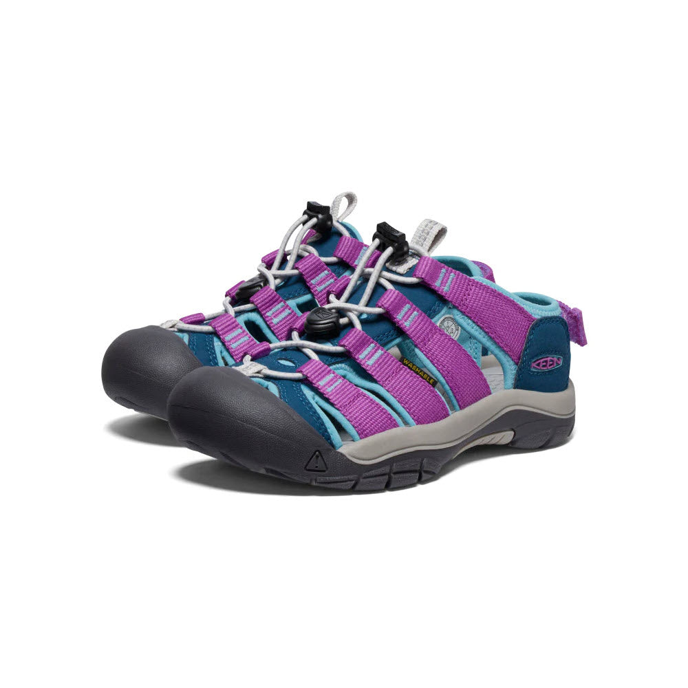 A pair of colorful Keen Newport Boundless Youth Legion Blue kids&#39; adventure sandals featuring purple, blue, and pink straps with toggle lacing and an adjustable heel strap on a white background.