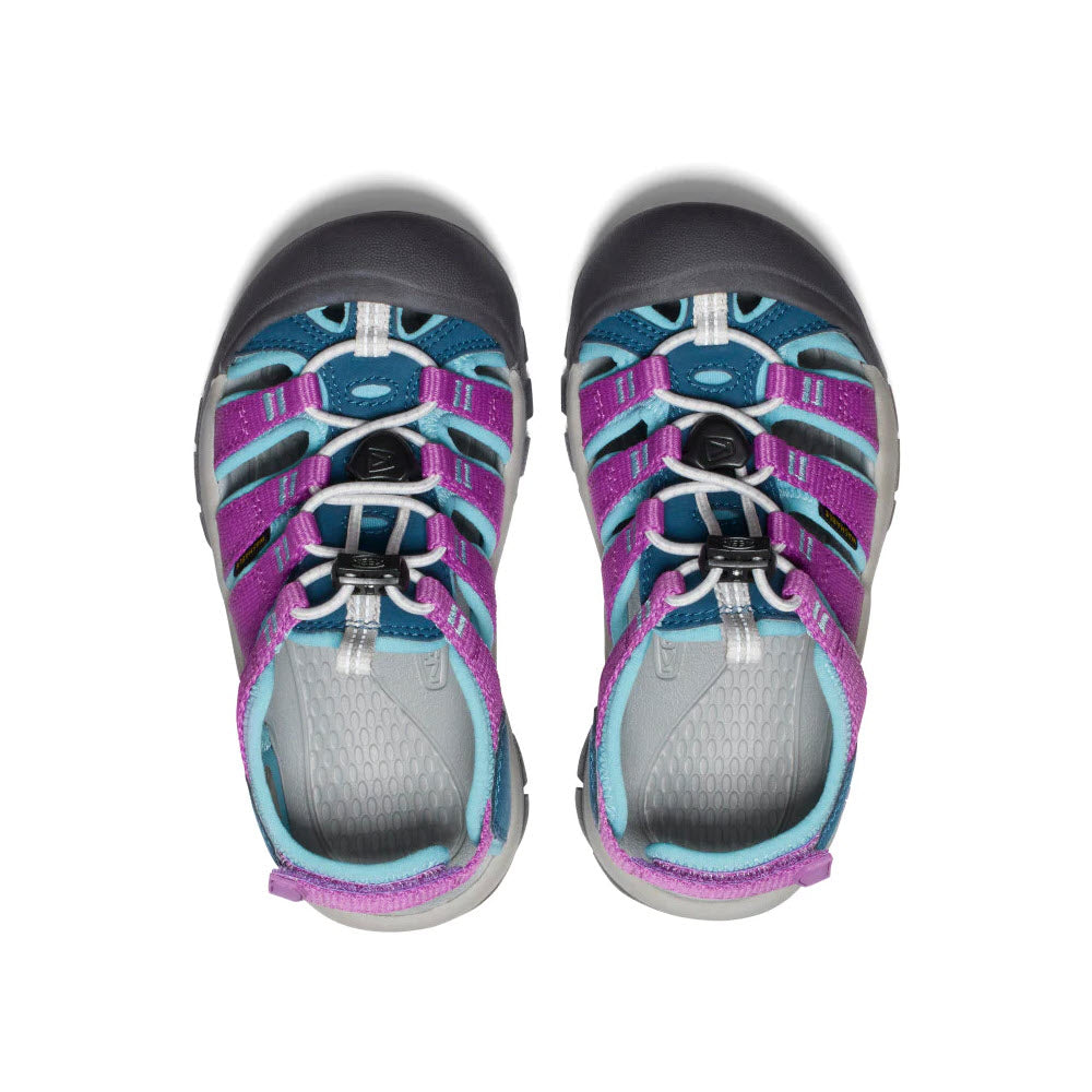 A pair of new Keen Newport Boundless Child Legion Blue - Kids hiking shoes viewed from above, featuring blue, purple, and gray straps with adjustable heel straps and black laces.