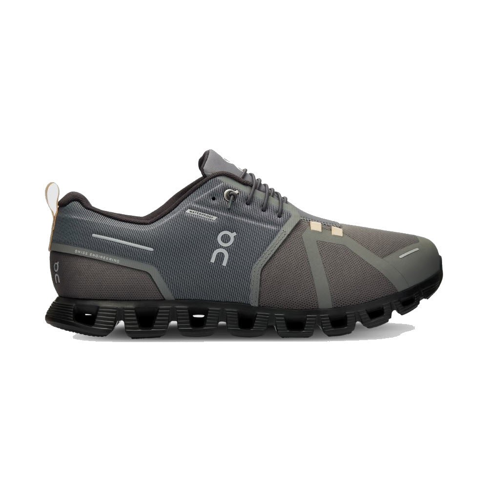 A side view of a ON CLOUD 5 WATERPROOF ASPHALT/MAGNET - MENS athletic shoe with gray and beige tones, crafted from sustainable materials, and featuring a distinctive thick, segmented sole.