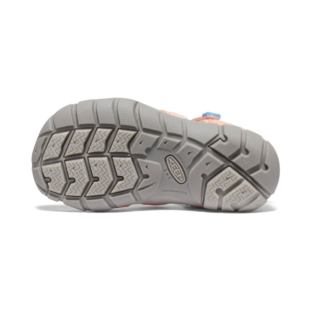 Bottom view of a Keen hiking shoe displaying a detailed tread pattern and a logo imprint on the sole, ideal for kids hybrid water sandals.