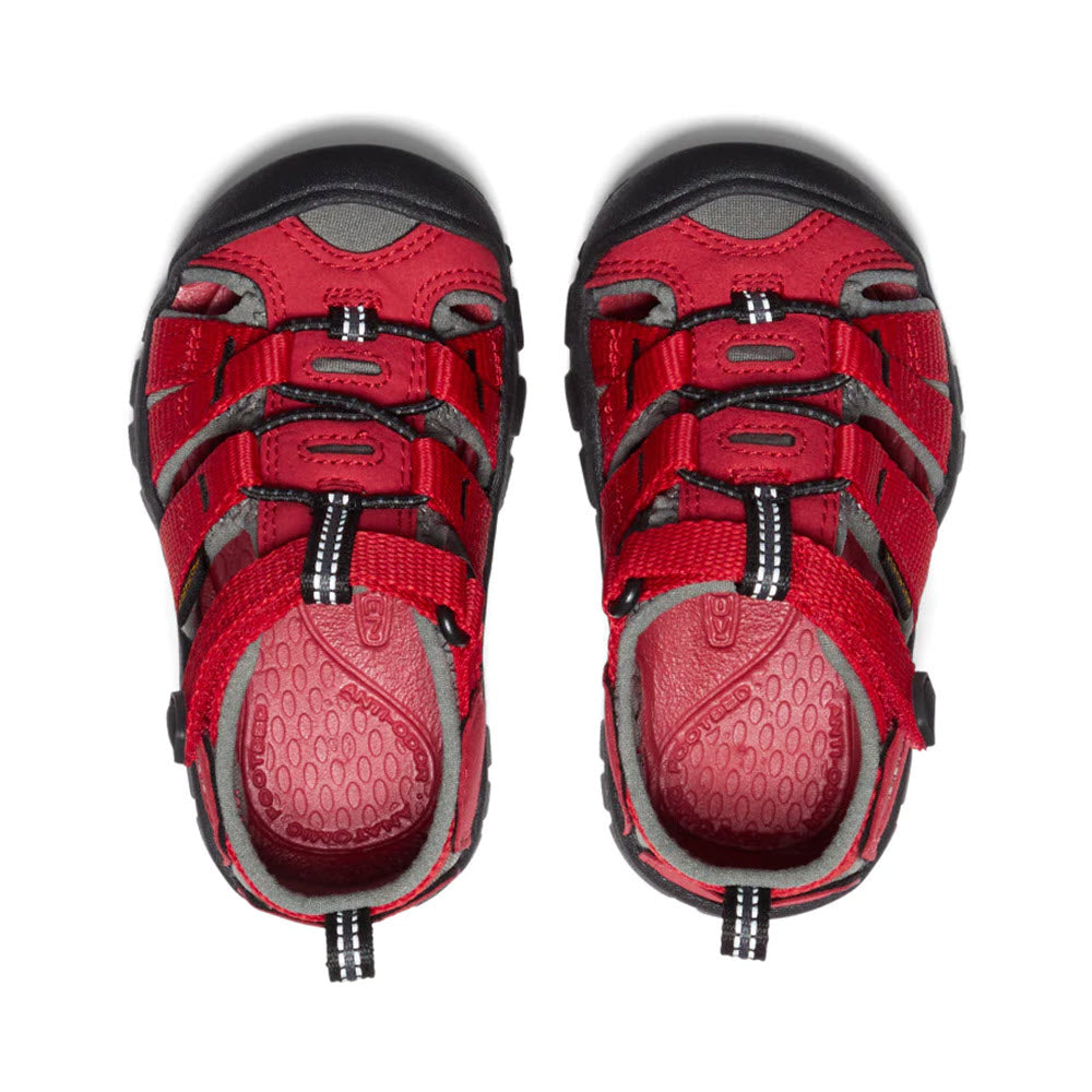 A pair of Keen SEACAMP II CNX Racing Red children&#39;s hybrid water sandals with black and gray accents, viewed from the top.