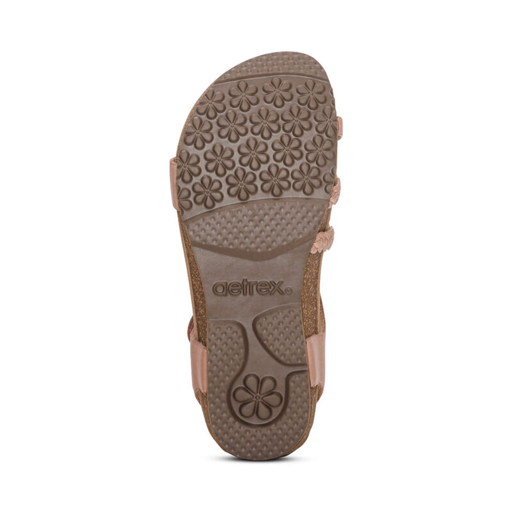 Bottom view of a brown Aetrex Jillian Rose - Womens quarter strap sandal showing the textured sole design with floral patterns.