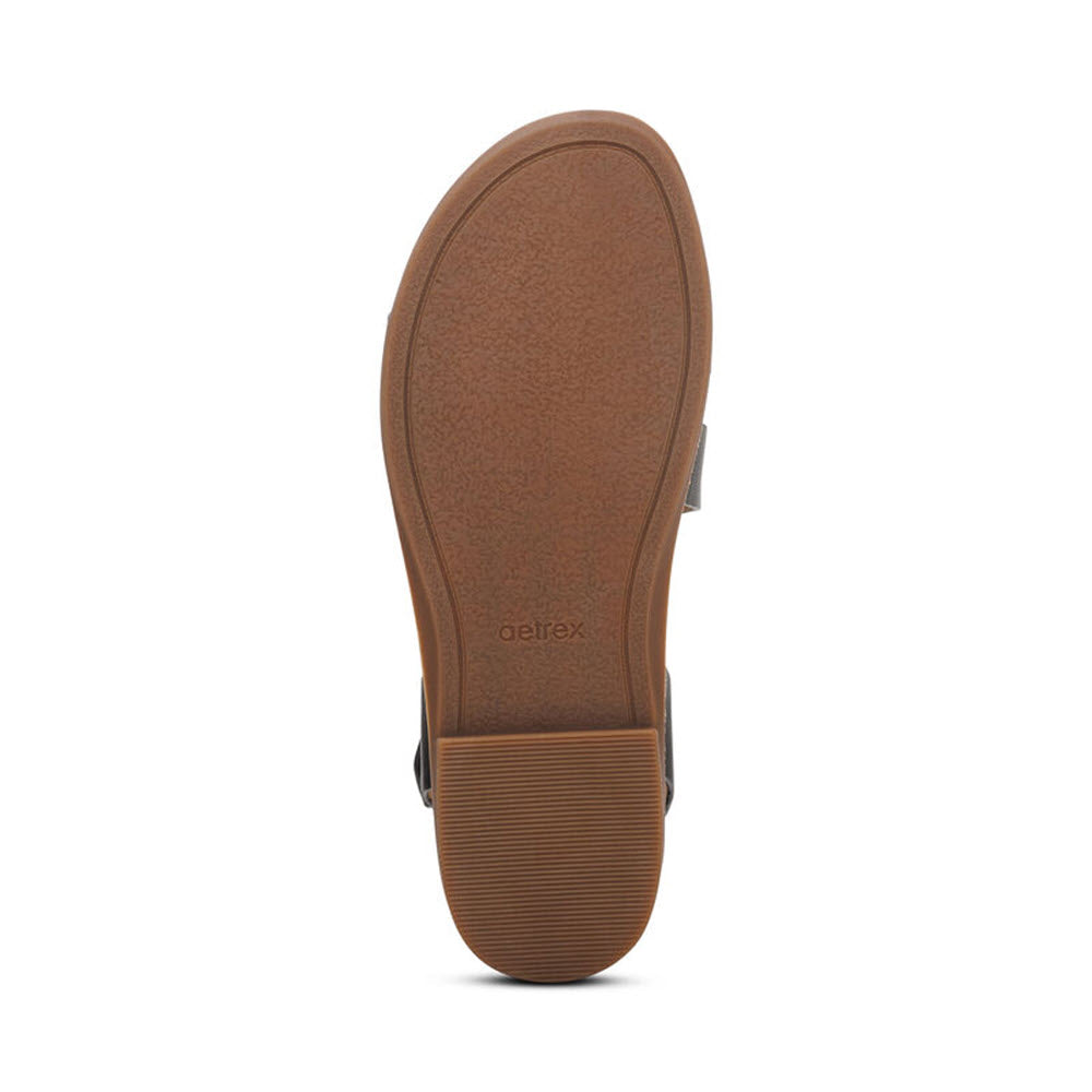 Sole of a shoe with textured brown surface and genuine leather upper, featuring the brand &#39;Aetrex&#39; visible on the heel area. The product is AETREX TAMARA BLACK - WOMENS by Aetrex.
