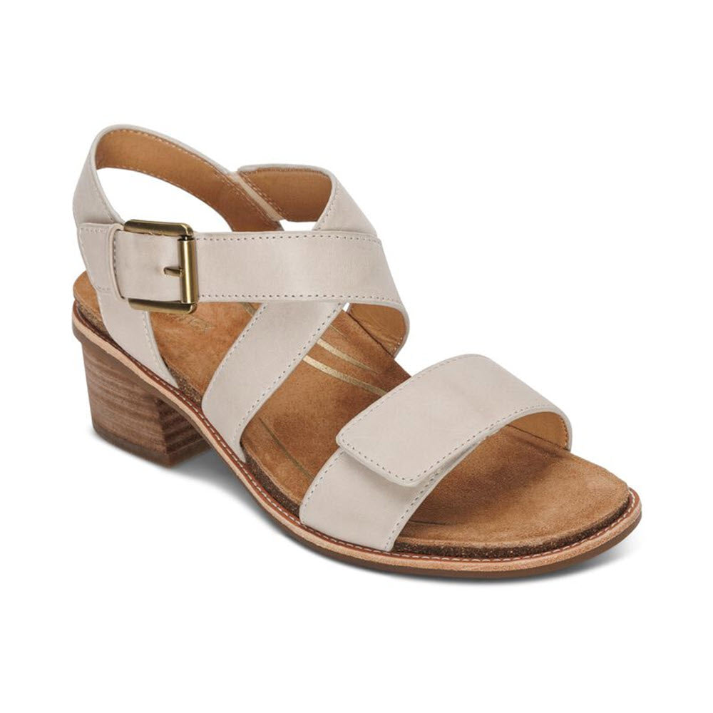 A Aetrex Kristin Ivory heeled sandal with wide straps, an adjustable hook and loop closure, and a wooden stacked heel, isolated on a white background.