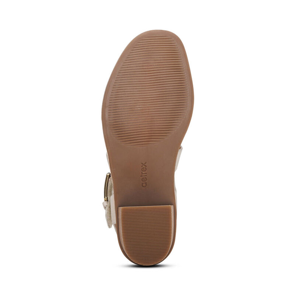 Bottom view of an Aetrex Kristin Ivory women&#39;s shoe with a smooth sole, memory foam footbed, and a label marked &quot;caretex.